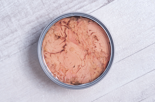 A downward view of a tin filled with tuna