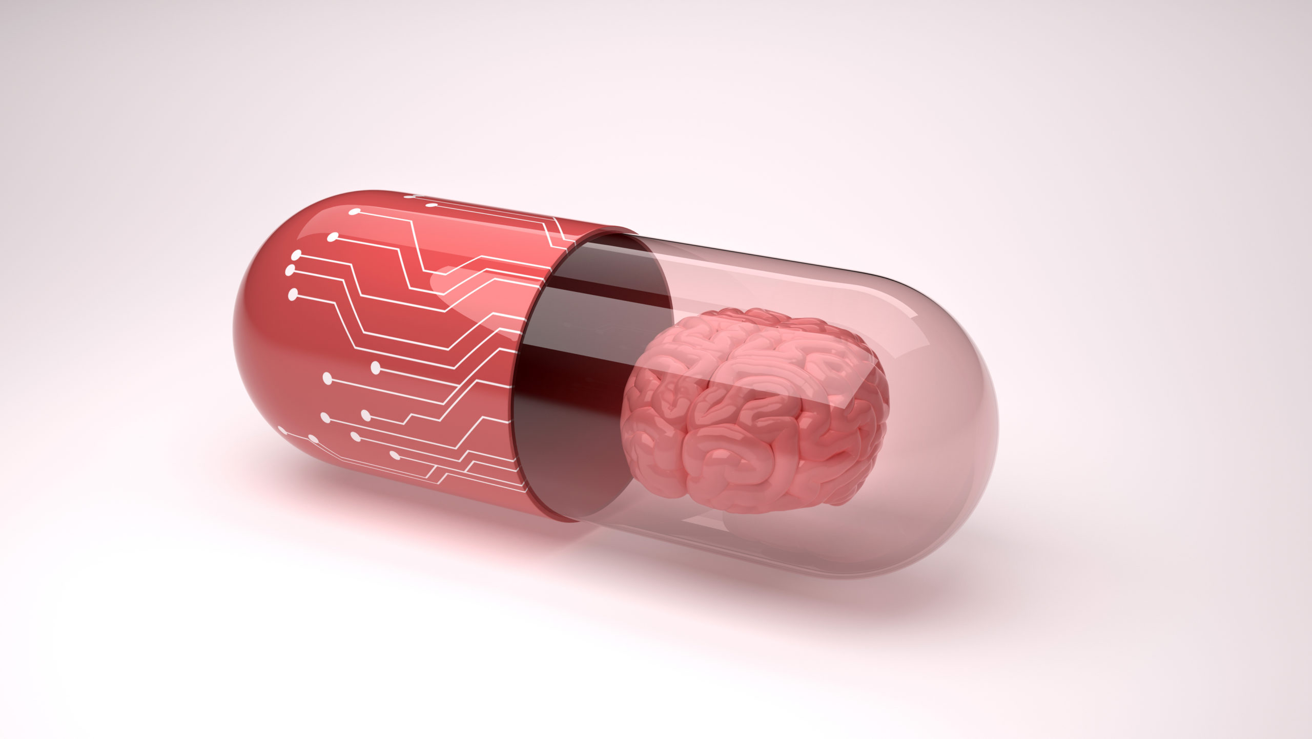 A red capsule pill of a little brain inside