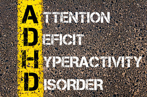 ADHD written out on the concrete floor with paint