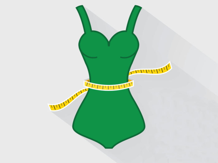 A green bikini with a tape measure around the waist
