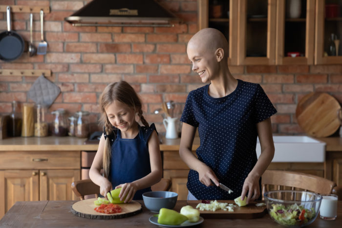 Woman cooking in the kitchen with her daughter