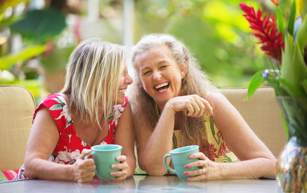 Two women laughing together on holiday