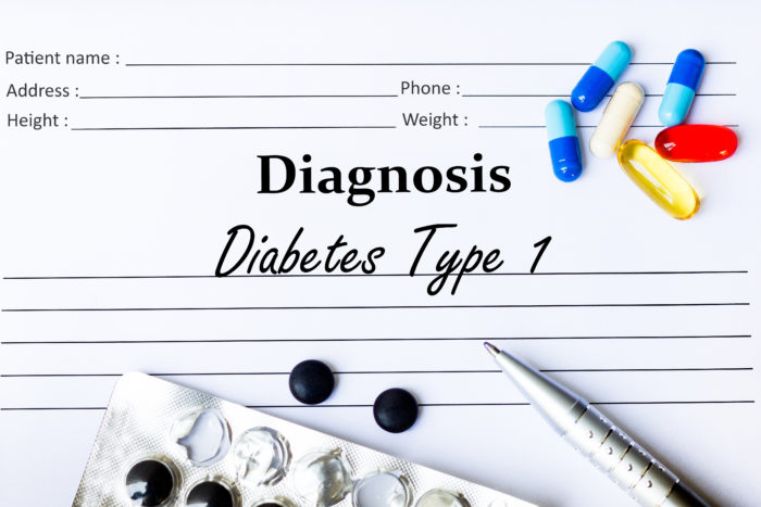 Diabetes Type 1 Diagnosis written down on paper surrounded by pills